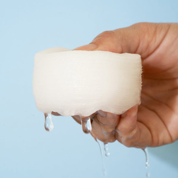 White container with a purple circle and a card labeled &
