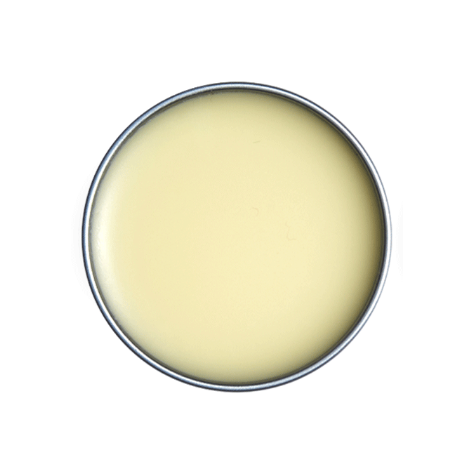 Close-up of a round container with a light yellow substance inside