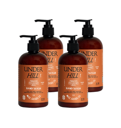 Four bottles of Under Hill hand wash with pump dispensers on a white background