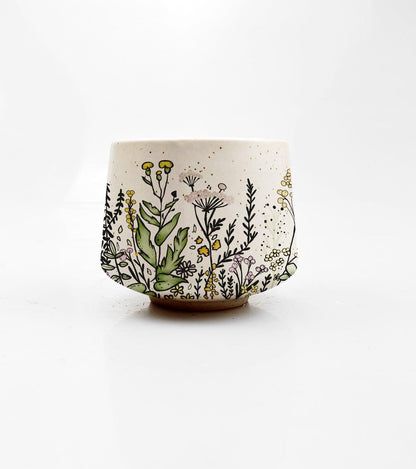 Ceramic cup with floral design on a white background