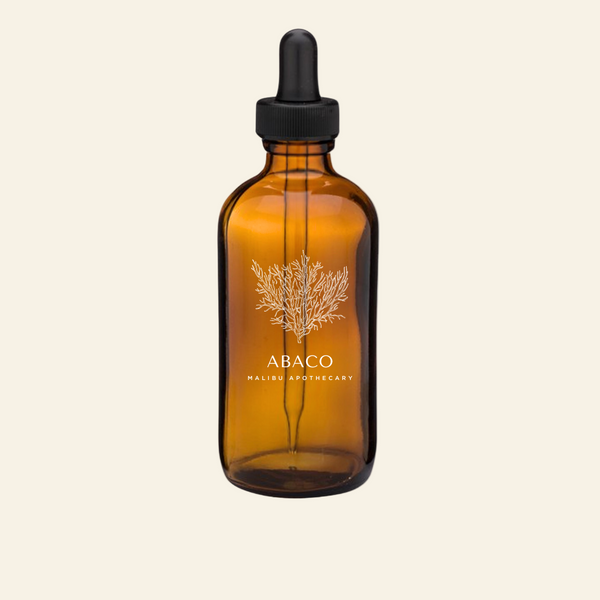 Amber glass dropper bottle with black cap on a white background, featuring the Abaco Malibu Apothecary logo.