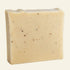 Bar of soap with specks on a white background