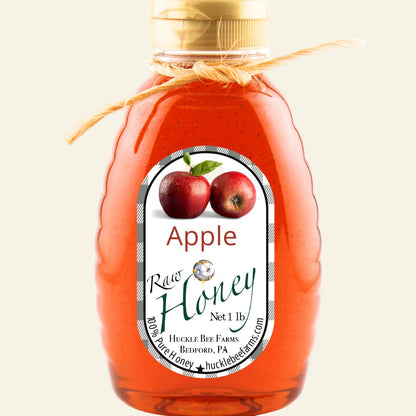 Bottle of apple honey with a label on a white background
