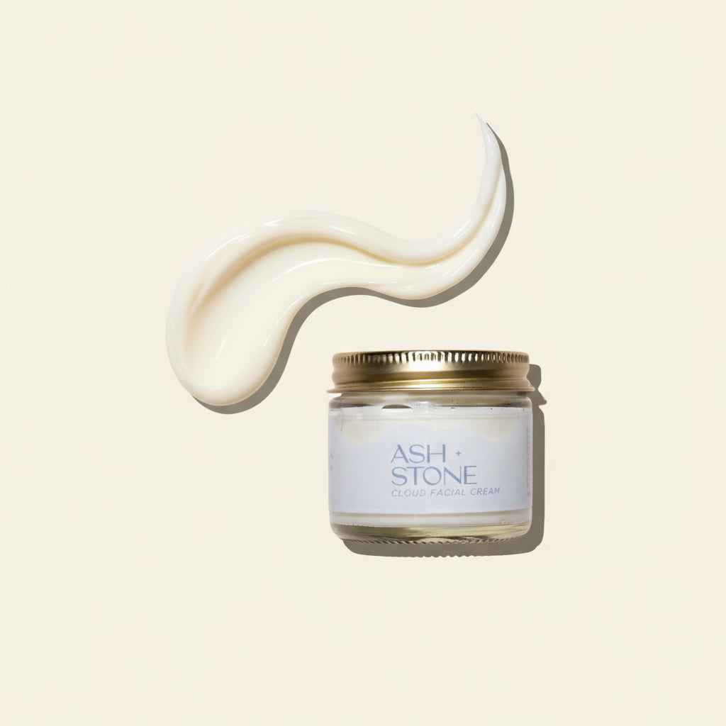 Jar of facial cream with a gold lid on a white background, featuring the brand &