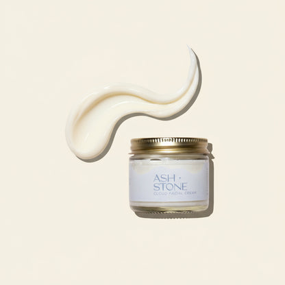 Jar of facial cream with a gold lid on a white background, featuring the brand &