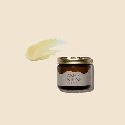 Jar of Ash + Stone balm with a swatch of balm on a white background