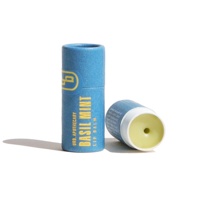 Two blue lip balm sticks with yellow text on a white background