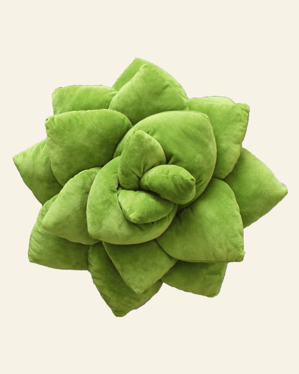 Green succulent-shaped pillow on a beige background