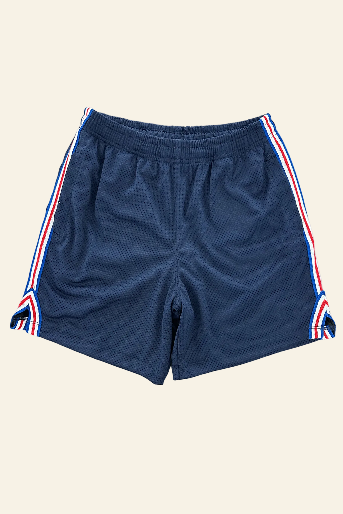 A pair of navy blue athletic shorts with white and red side stripes, shown flat against a plain white background.