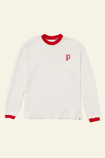 White long-sleeve shirt with red trim and logo on a white background