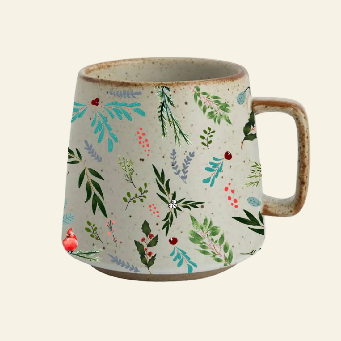 A handmade ceramic mug with a textured beige base, decorated with a colorful botanical pattern of green leaves, blue foliage, and small red berries, featuring a rustic brown handle and rim.