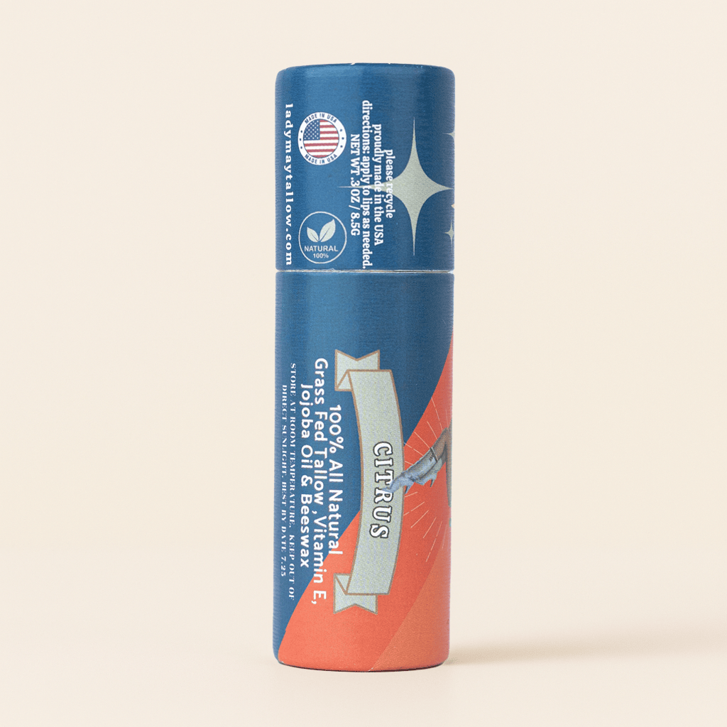 A single tube of Citrus Zing all natural citrus oil and balm stick, featuring a blue and orange design with white text, set against a solid cream background.