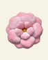 Pink flower-shaped pillow on a beige background