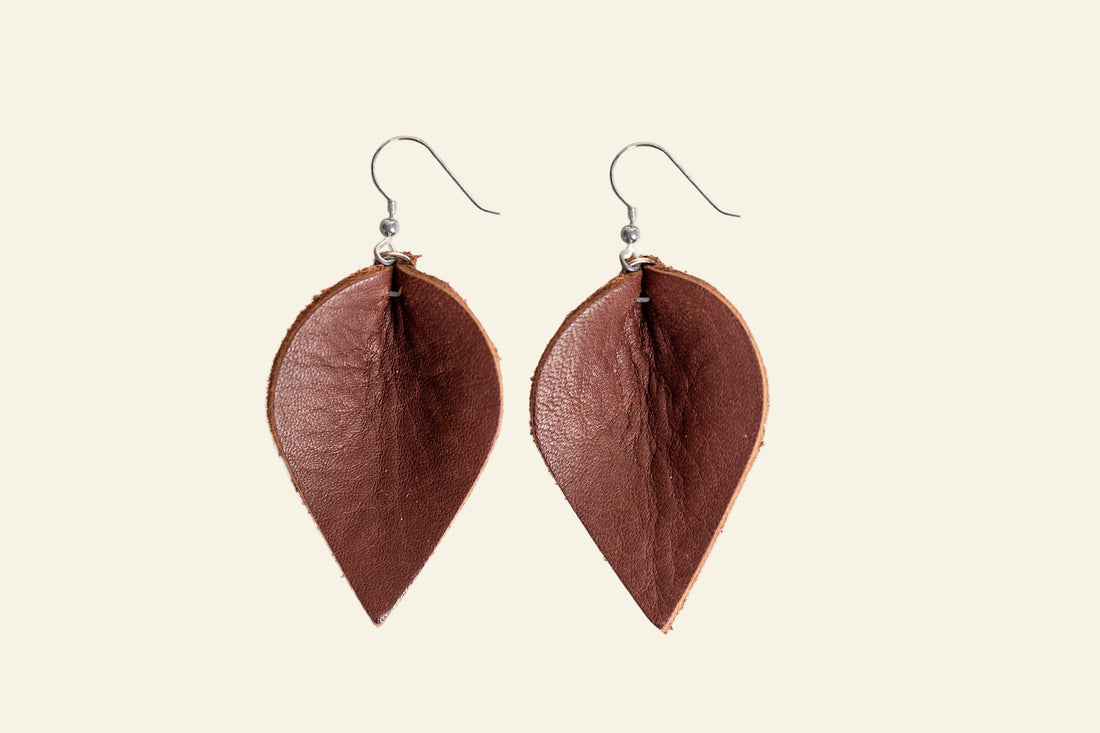 Brown leaf-shaped earrings on a white background