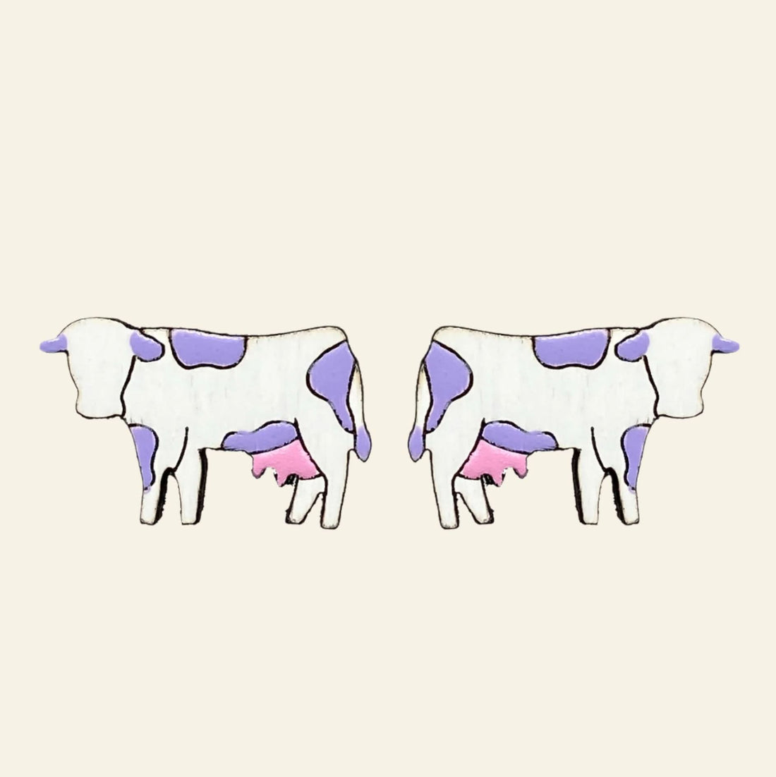 Pair of cow-shaped earrings with purple and pink spots on a white background