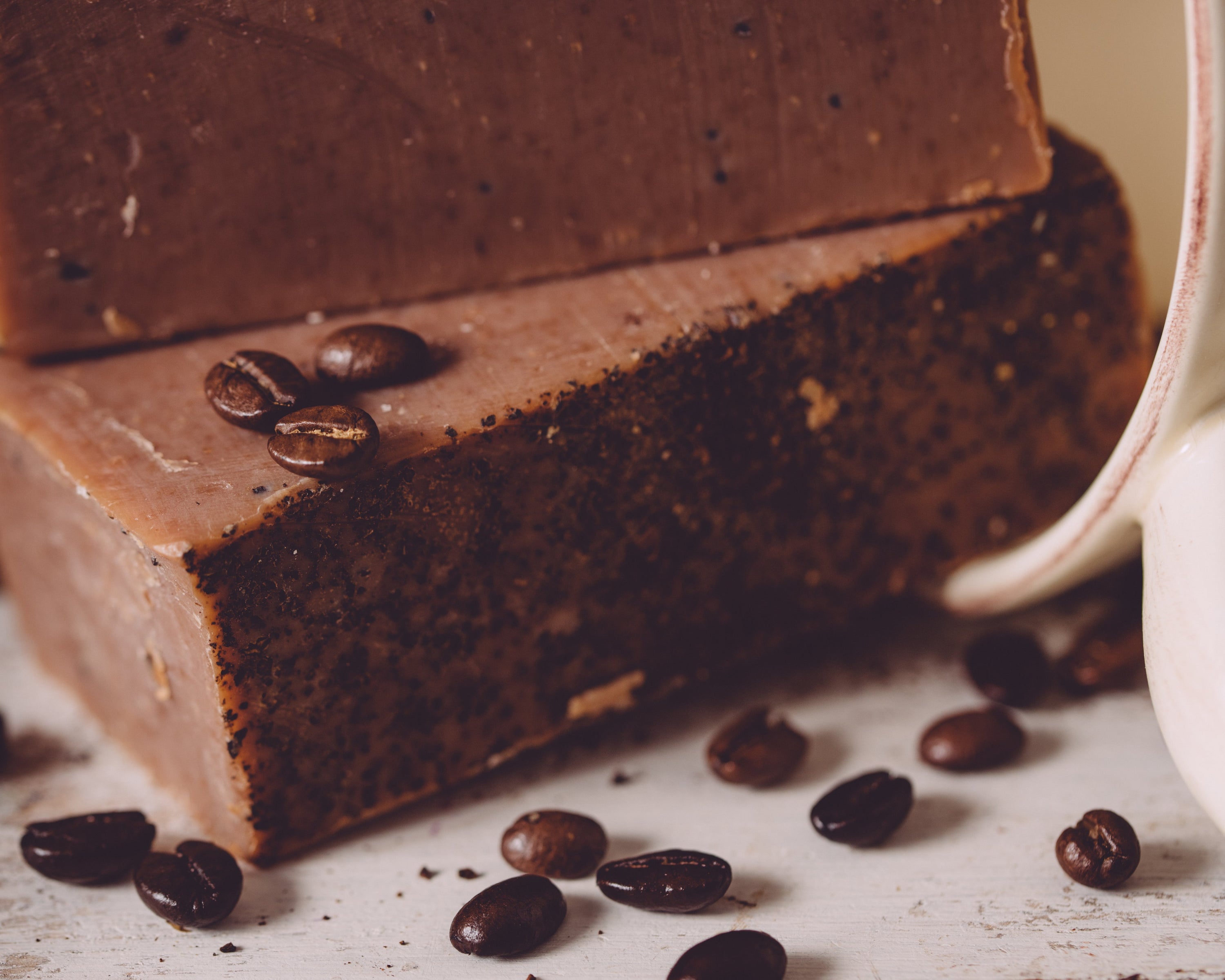 Chocolate cake with coffee beans on a rustic surface