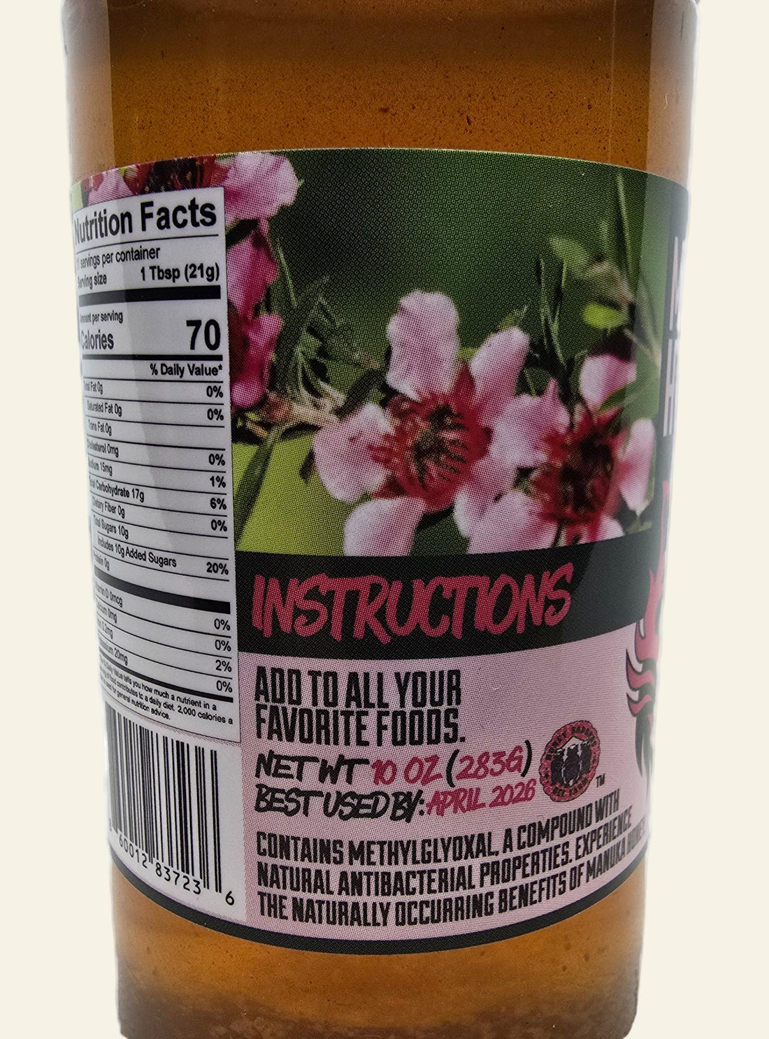 Bottle with a label featuring flowers and text on a white background