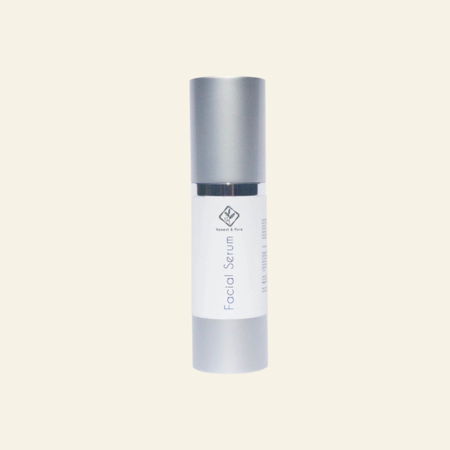 Facial serum bottle with silver cap and white body on a light gray background