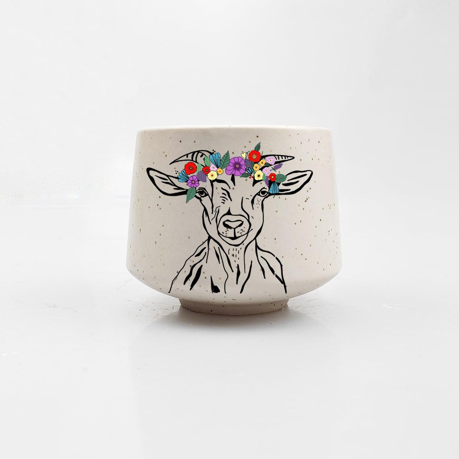 Ceramic pot with a goat illustration and floral crown on a white background