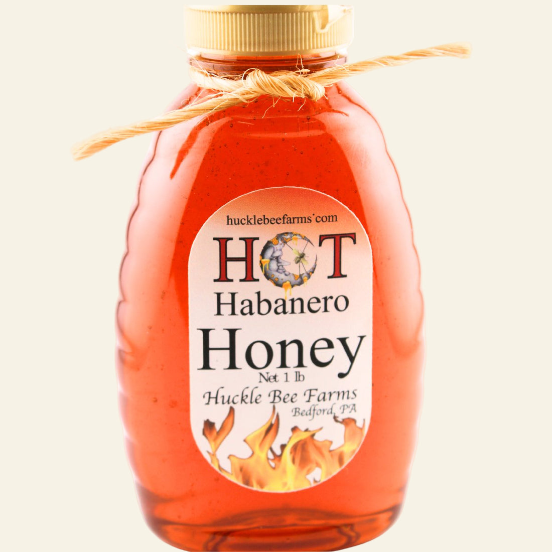 Bottle of Hucklebee Farms Hot Habanero Honey on a white background
