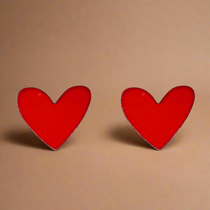 Red heart-shaped earrings on a white background