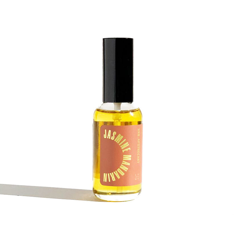 Bottle of Jasmine perfume with a black cap on a white background