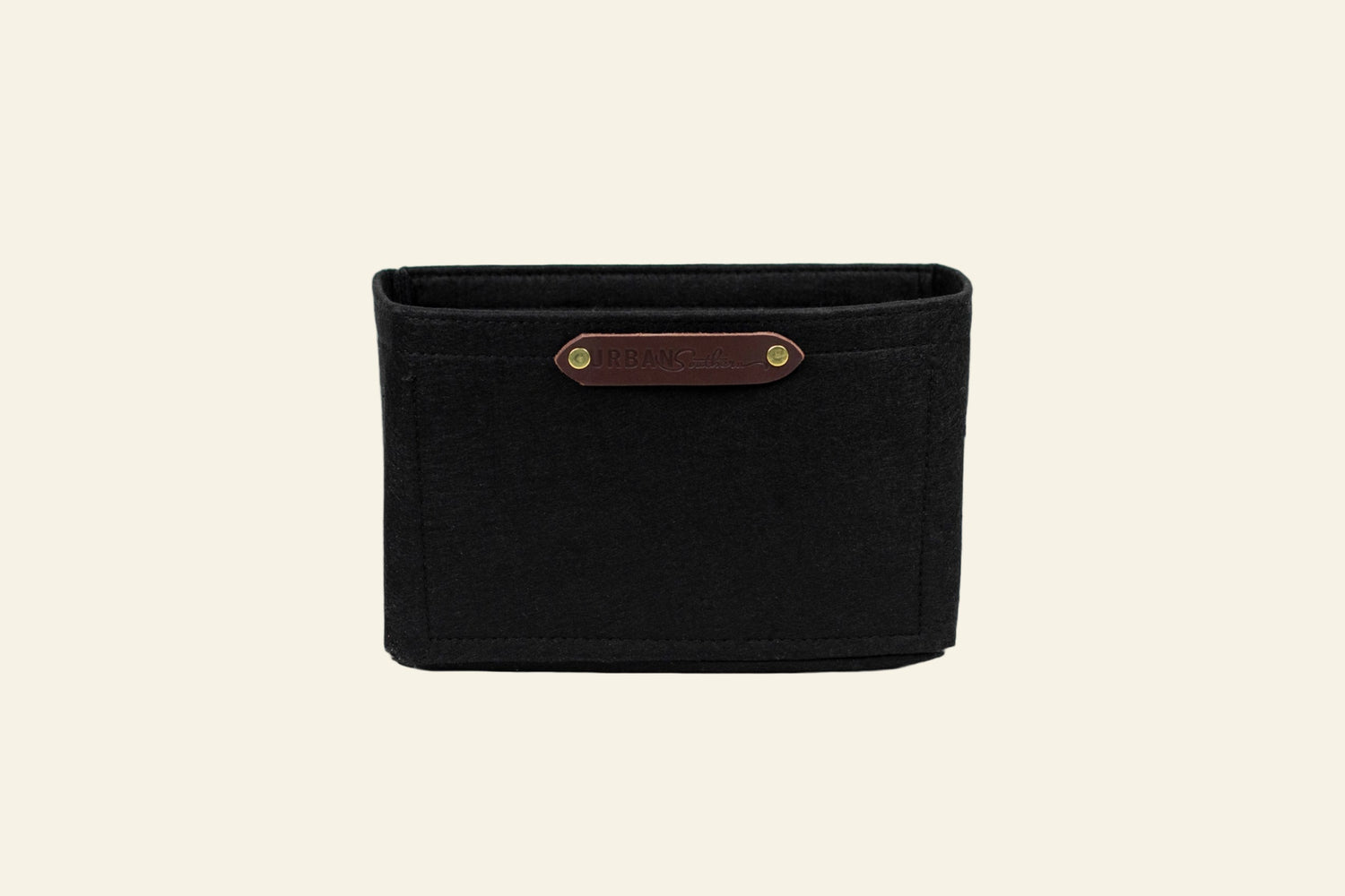 Black woven basket with a brown leather strap on a white background