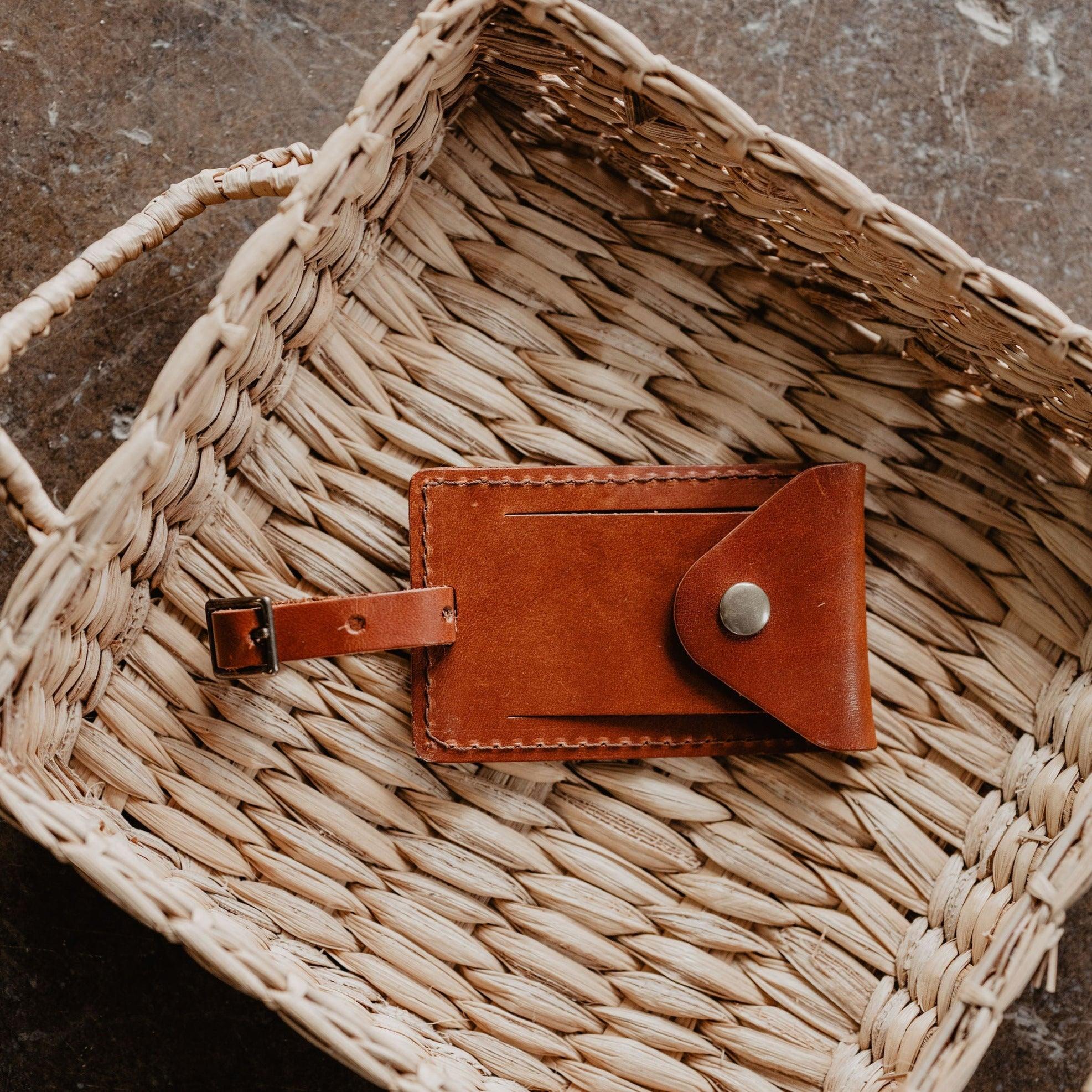 Brown leather luggage tag on a woven basket