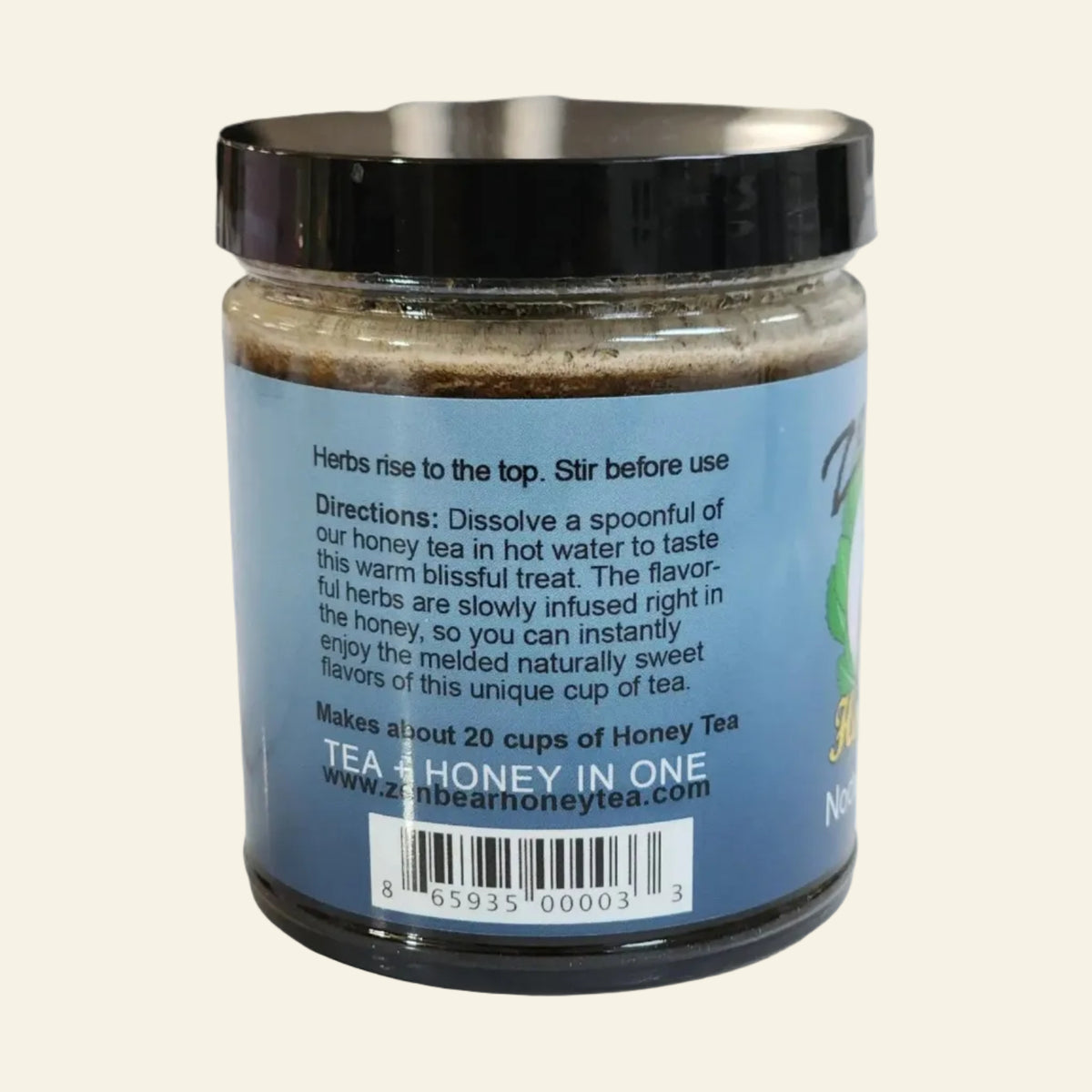 A jar of honey tea with a black lid and a blue label showing directions and a barcode, photographed against a white background.