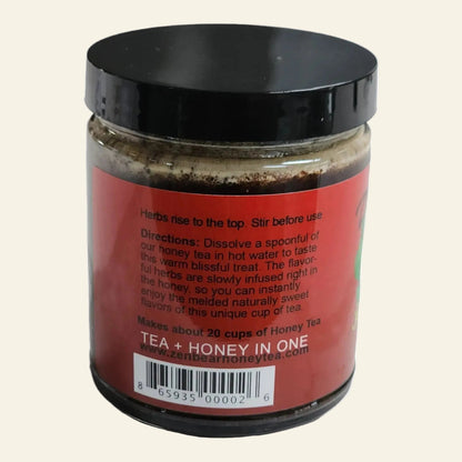 A jar of Tea + Honey In One by Bear &amp; Bee Tea Co., featuring a red label with black text and a black lid, shown against a plain white background.