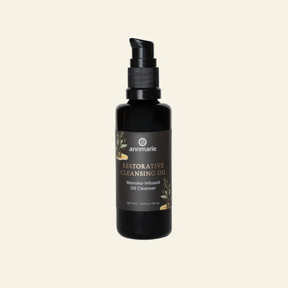 Black bottle of Annmarie Restorative Cleansing Oil on a white background