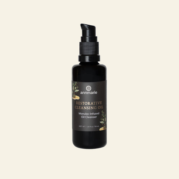 Black bottle of Annmarie Restorative Cleansing Oil on a white background
