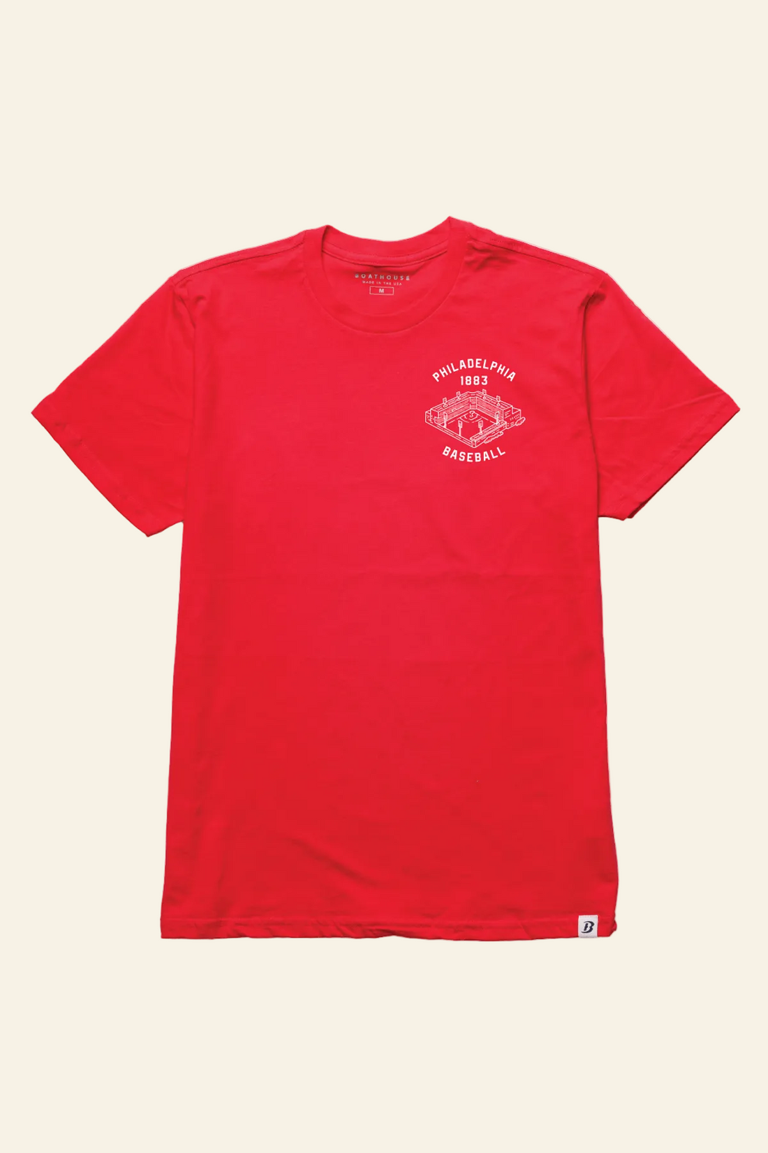 A red short-sleeve crewneck t-shirt with a white circular graphic on the left chest reading &
