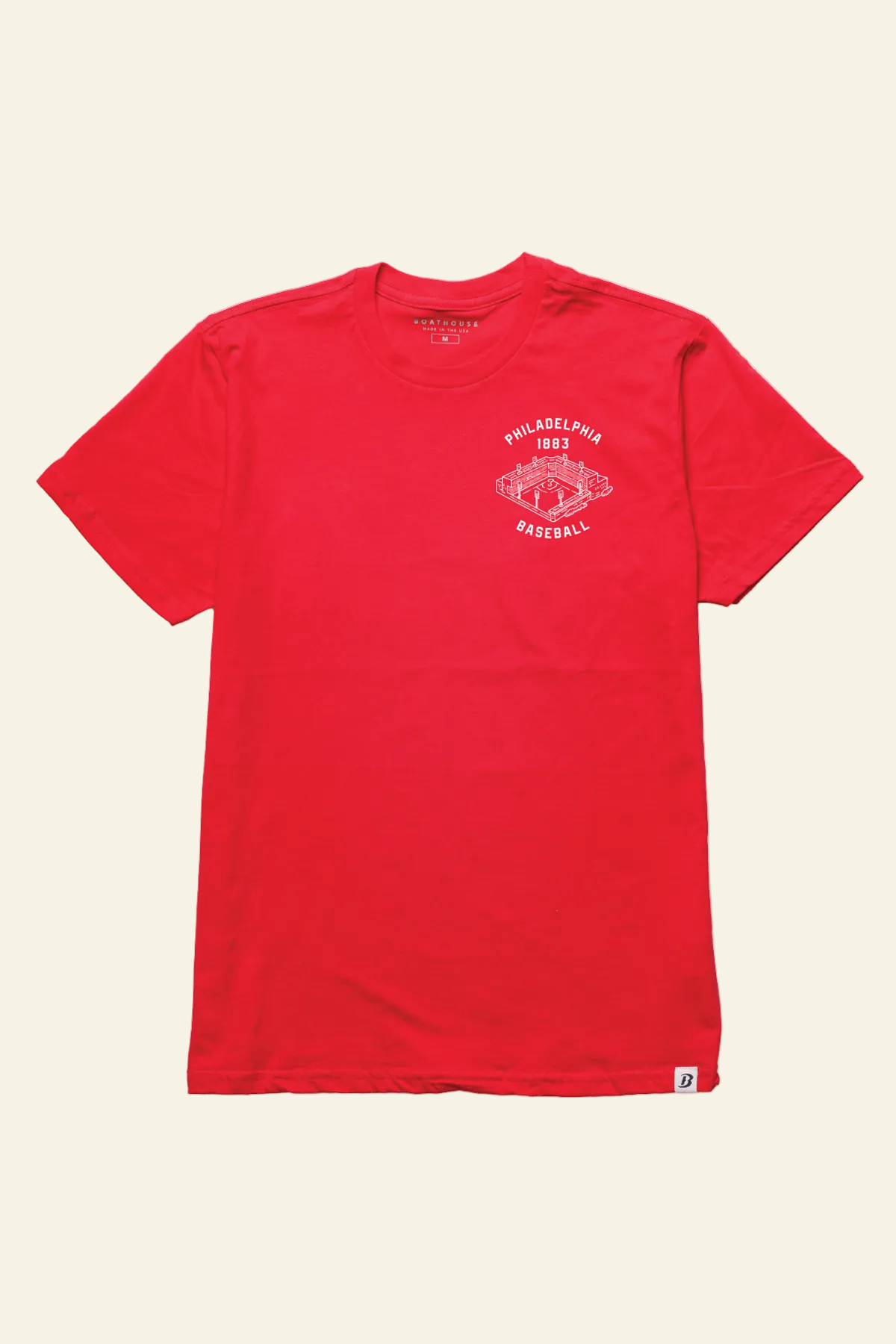 A red short-sleeve crewneck t-shirt with a white circular graphic on the left chest reading &