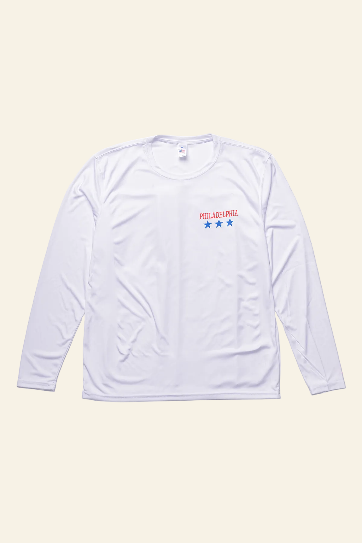A white long-sleeve athletic shirt with a small chest graphic featuring the text &