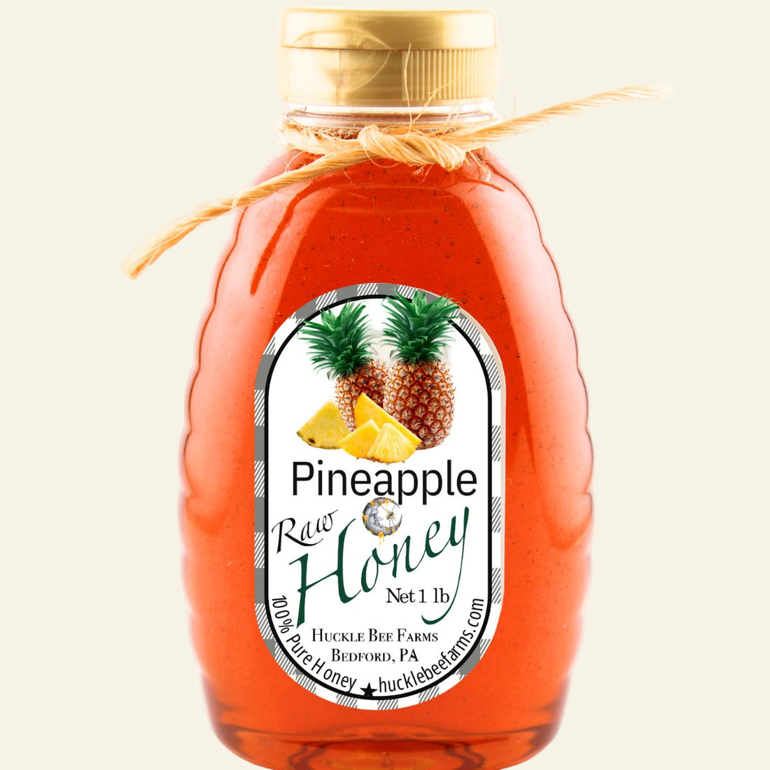 Bottle of pineapple raw honey with a label on a white background
