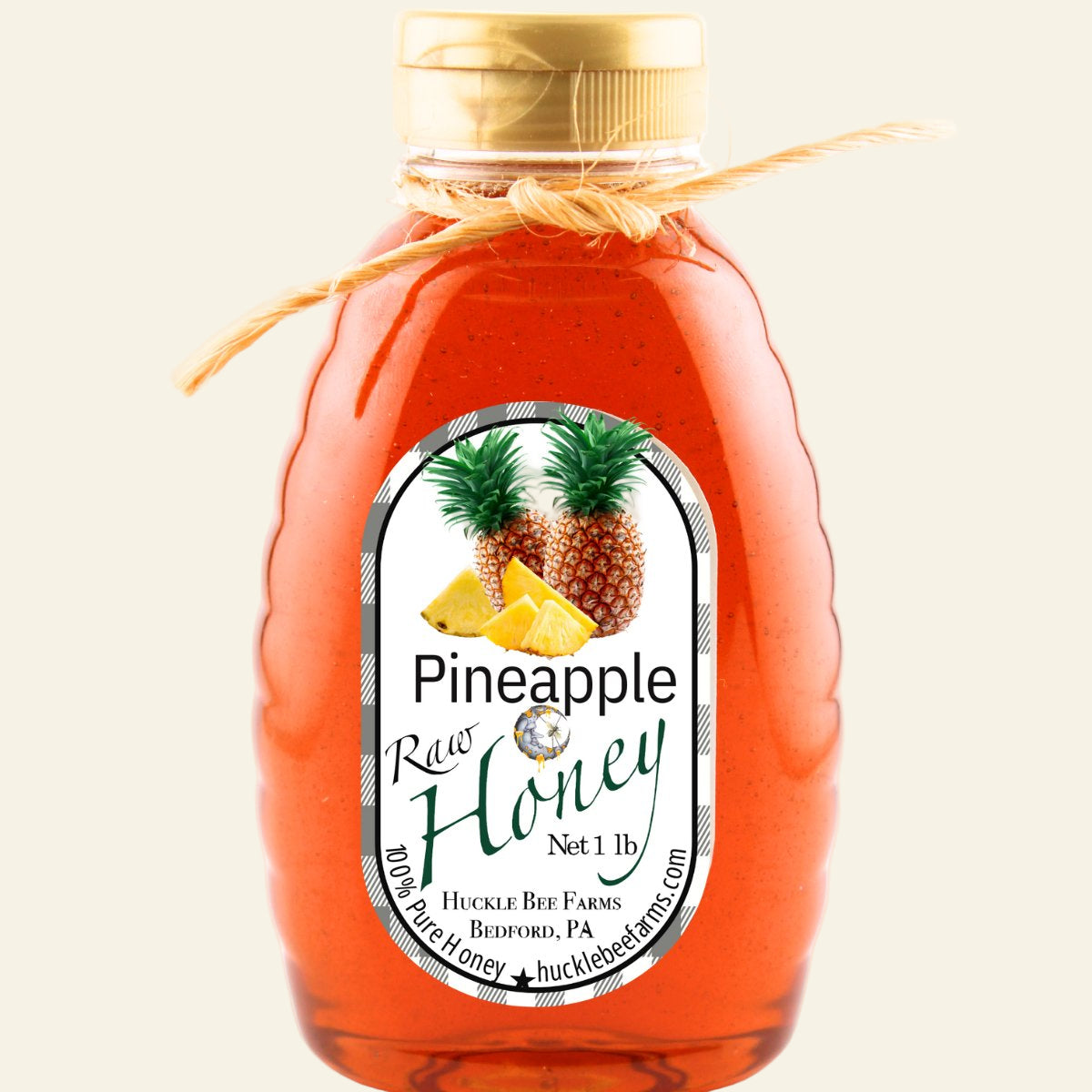 Bottle of pineapple raw honey with a label on a white background