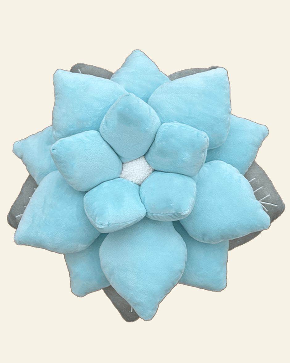 Blue succulent-shaped pillow on a beige background