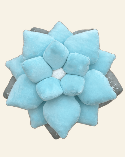 Blue succulent-shaped pillow on a beige background