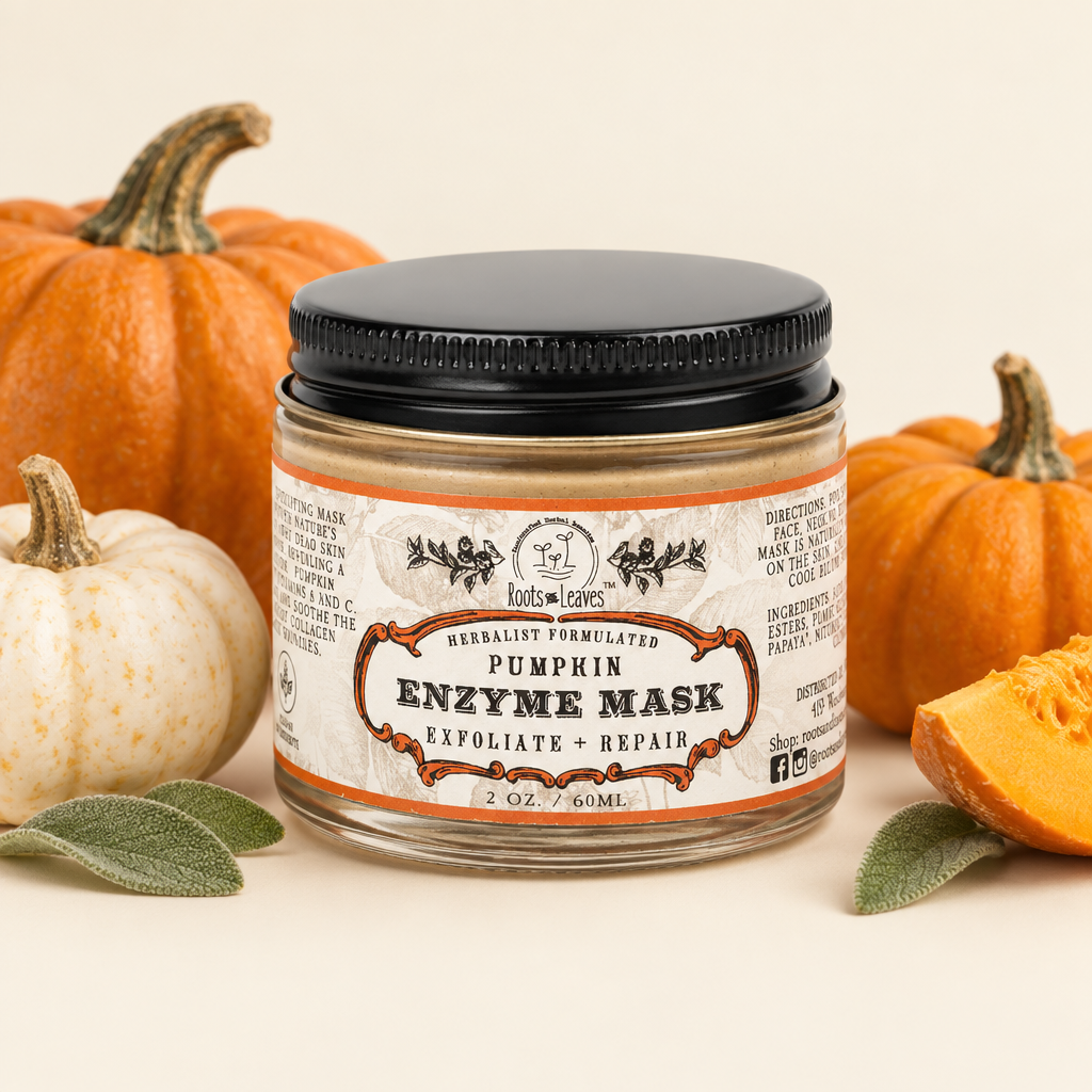 Roots of Leaves Pumpkin Enzyme Mask in a 2 oz glass jar with a black screw-on lid, gold metallic rim, and a white label with orange accents.