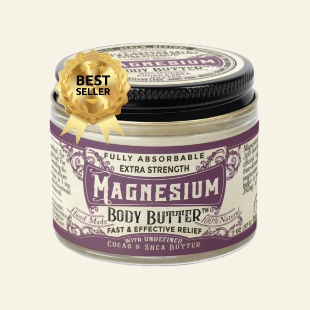 A jar of Magnesium Body Butter with a black lid and a cream-colored label featuring purple text and borders. A gold &
