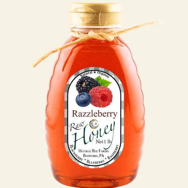 Bottle of Razzleberry Raw Honey with a label featuring berries on a white background