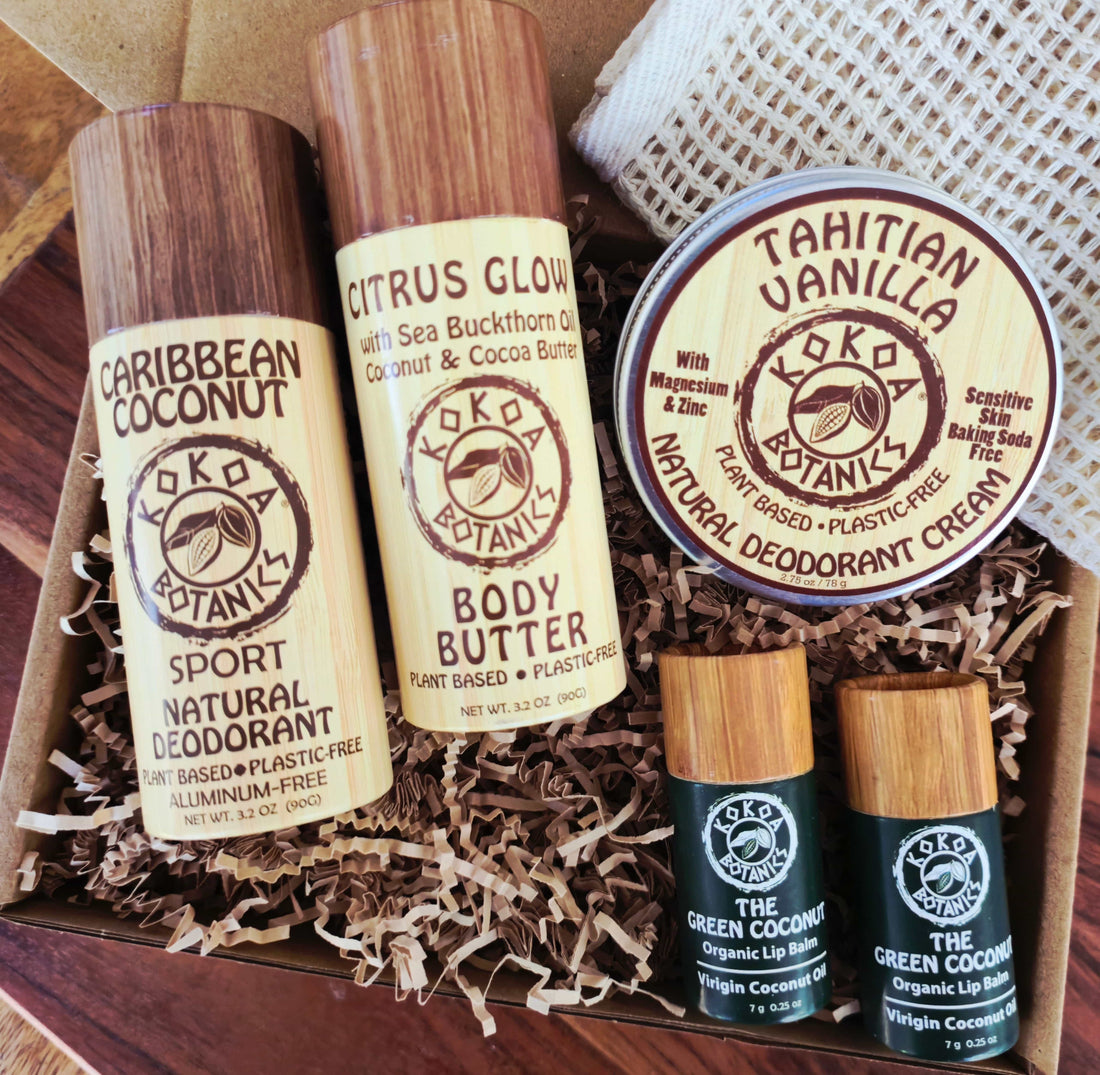 KOKOA BOTANIKS skincare and body care products including deodorant, body butter, and lip balm in a box.
