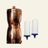 Copper filtration system with two ceramic candles on a beige background, labeled &
