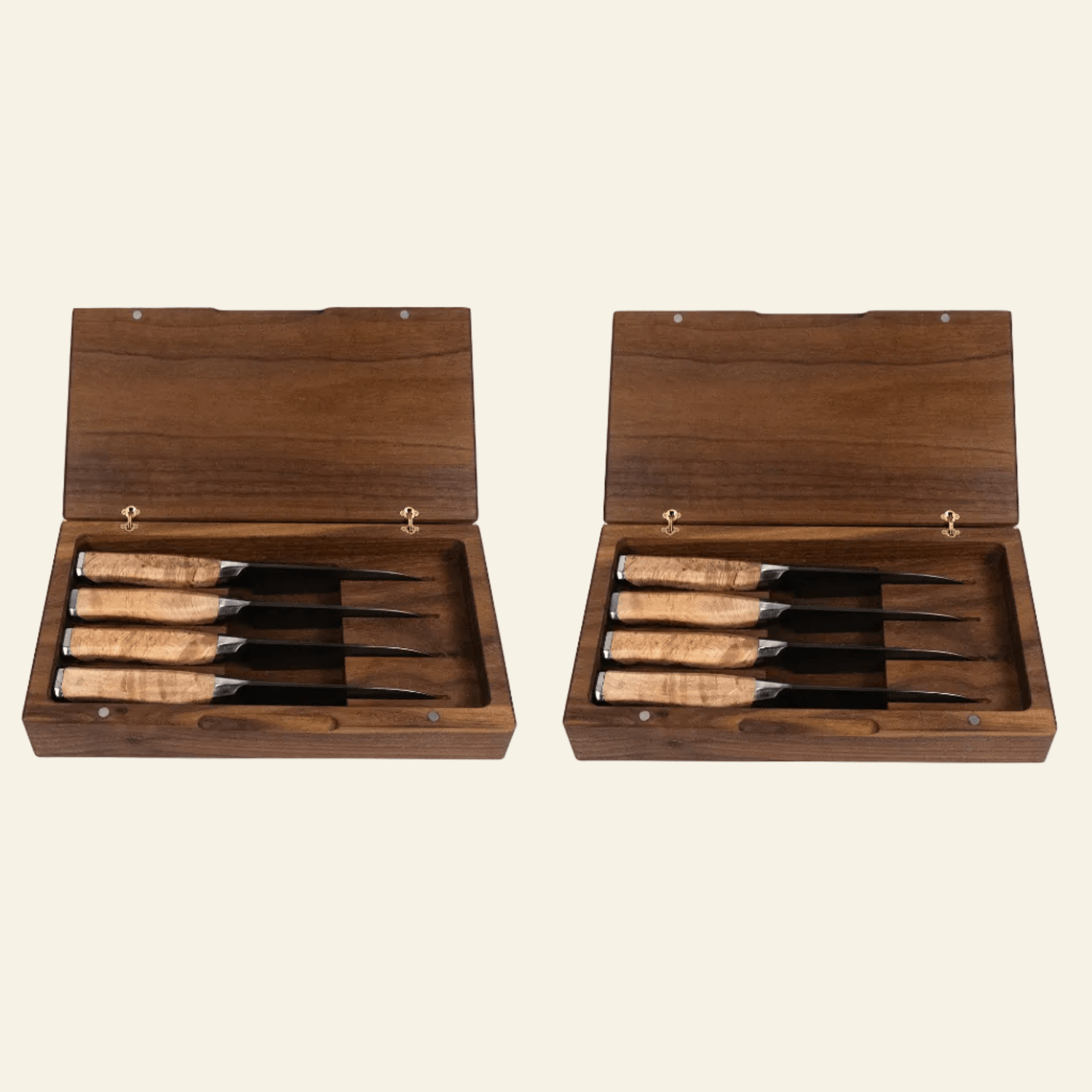 Set of four knives with wooden handles in a wooden box on a beige background