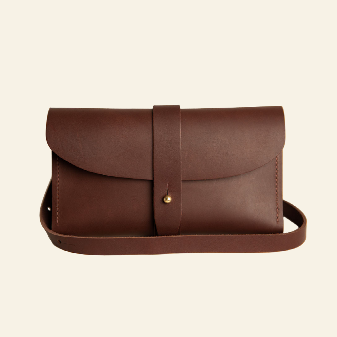 Brown leather crossbody bag on a white background