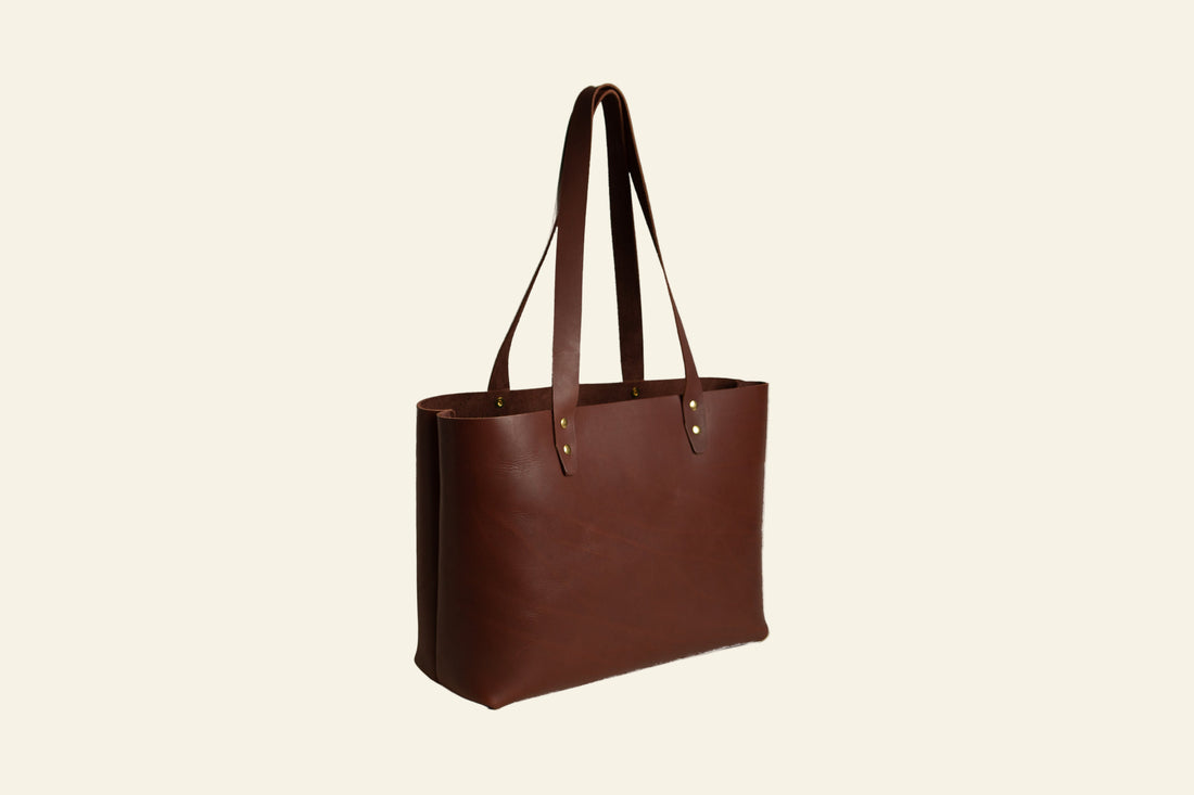 Brown leather tote bag on a white background