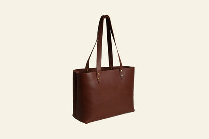 Brown leather tote bag on a white background