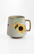 Ceramic mug with sunflower design on a white background