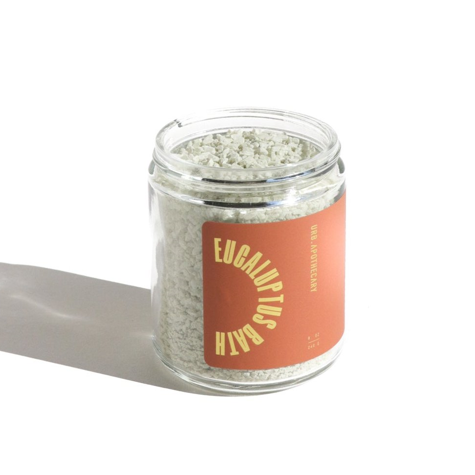 Jar of Eucalyptus Balm with a pink label on a white background